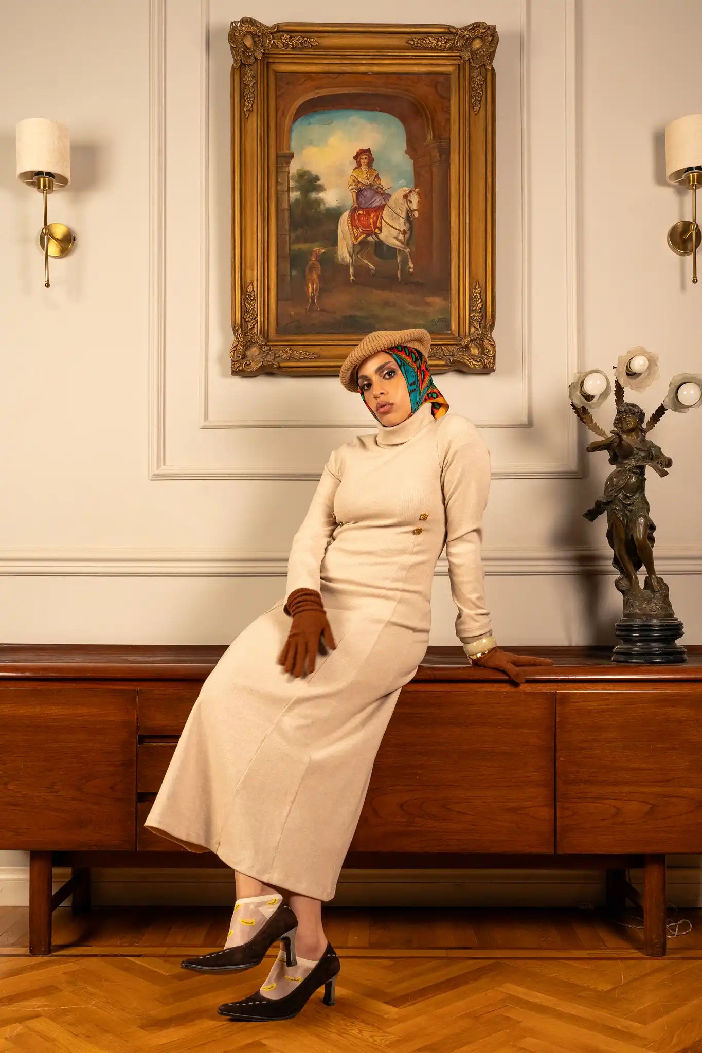 Model wearing an iconic ivory dress with a soft ivory color and minimalist elegant design