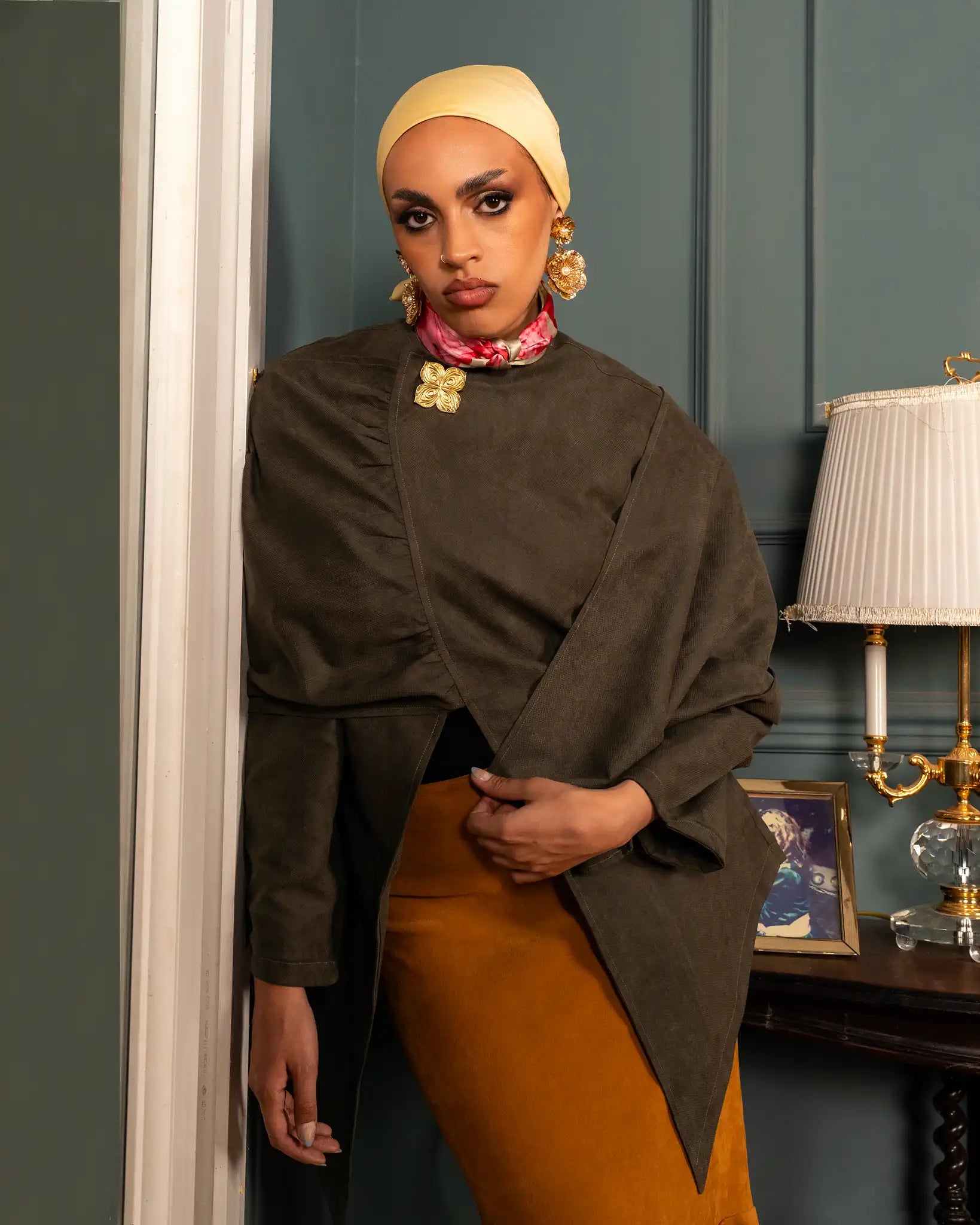 Olive empress cape with an earthy olive tone and flowing elegant silhouette, combining strength, grace, and refined style