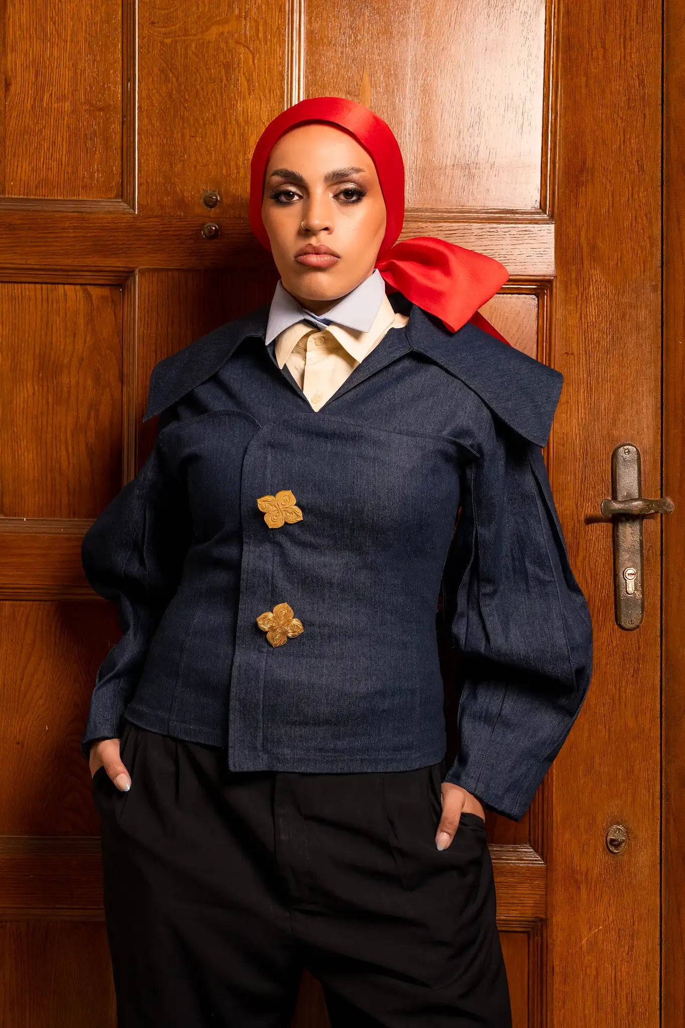 Model wearing a royal crest top with a refined design that reflects heritage elegance and strong identity